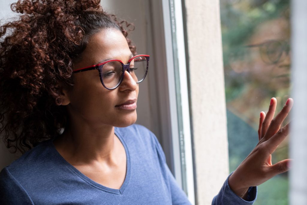 Black woman looking out the window