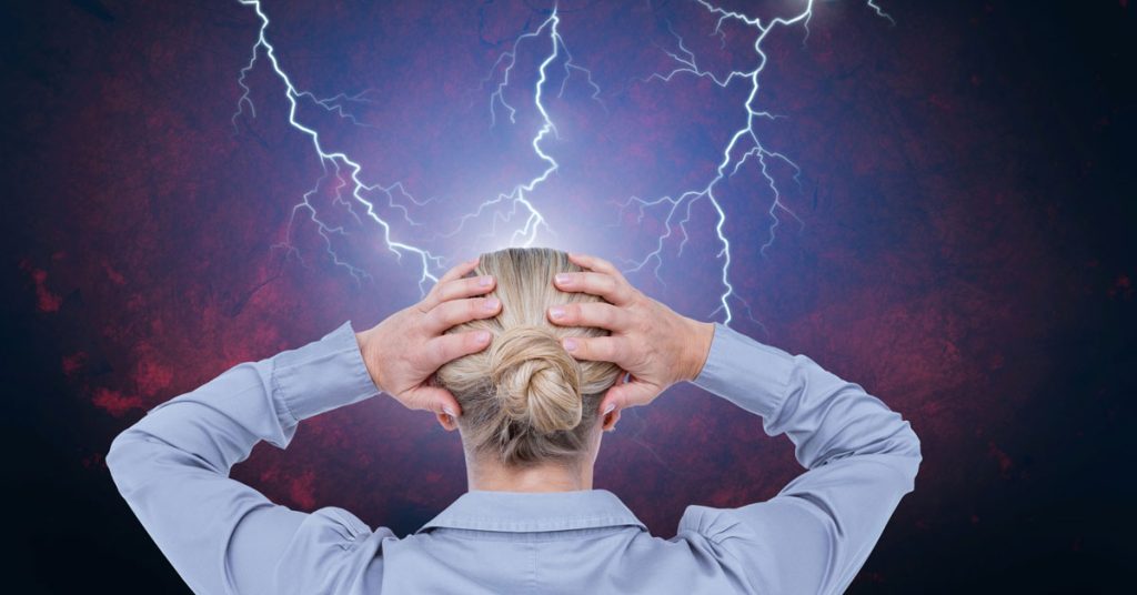 overwhelmed woman with hands on head as lightning strikes around her