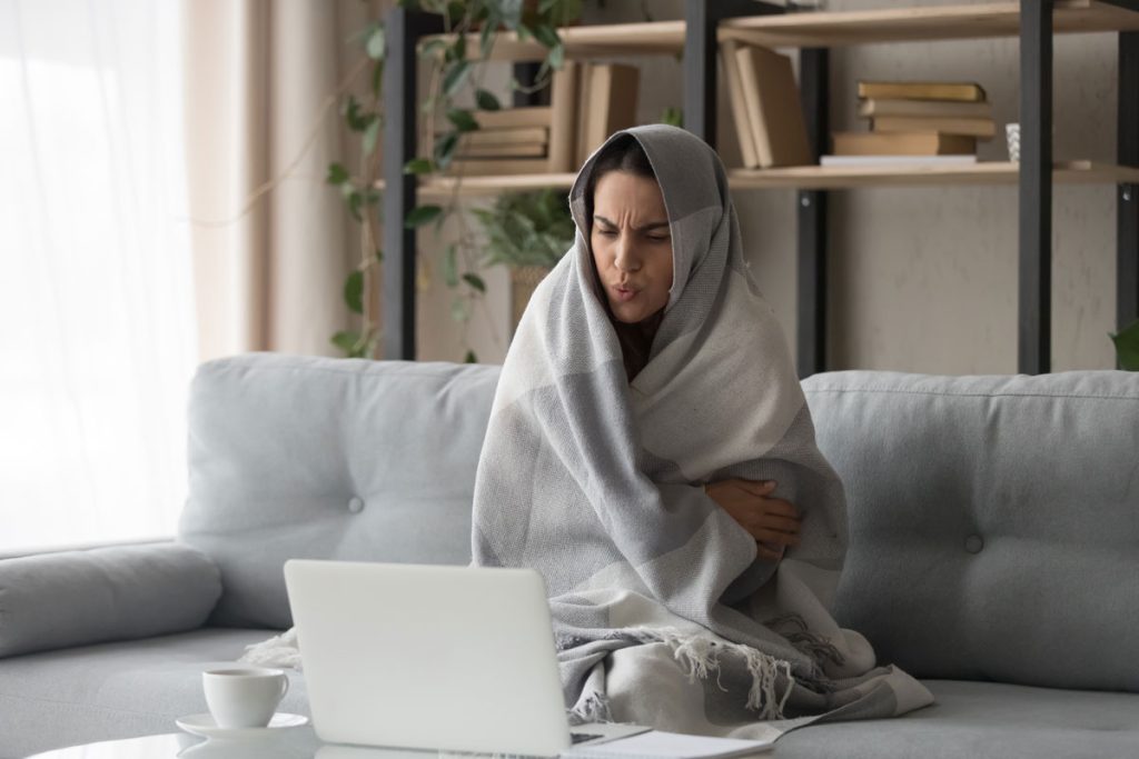 cold woman wrapped up in blanket to escape menopause cold flash