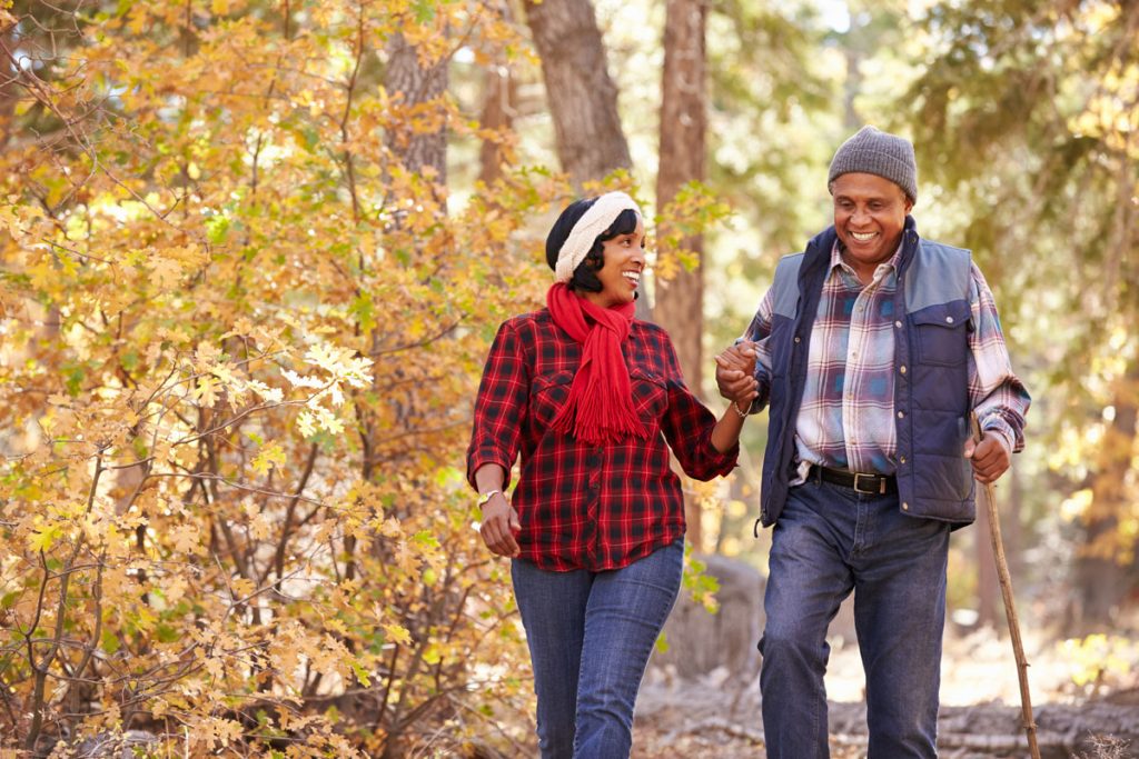 happy couple walking through woods anger free