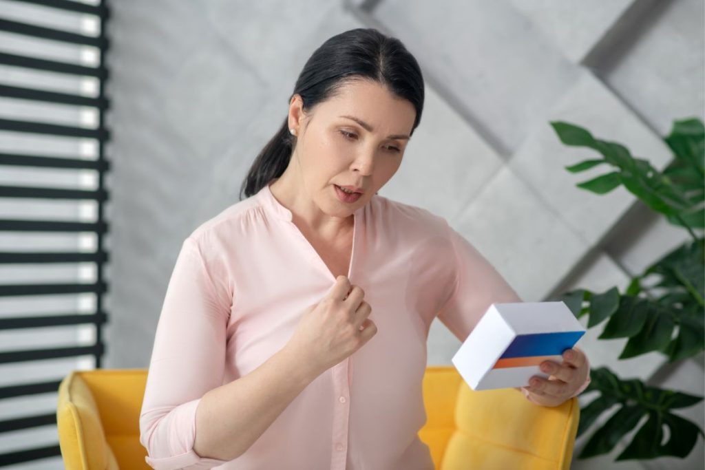 woman having a hot flash looking at Hormone Replacement Therapy