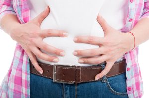 woman holding bloated stomach