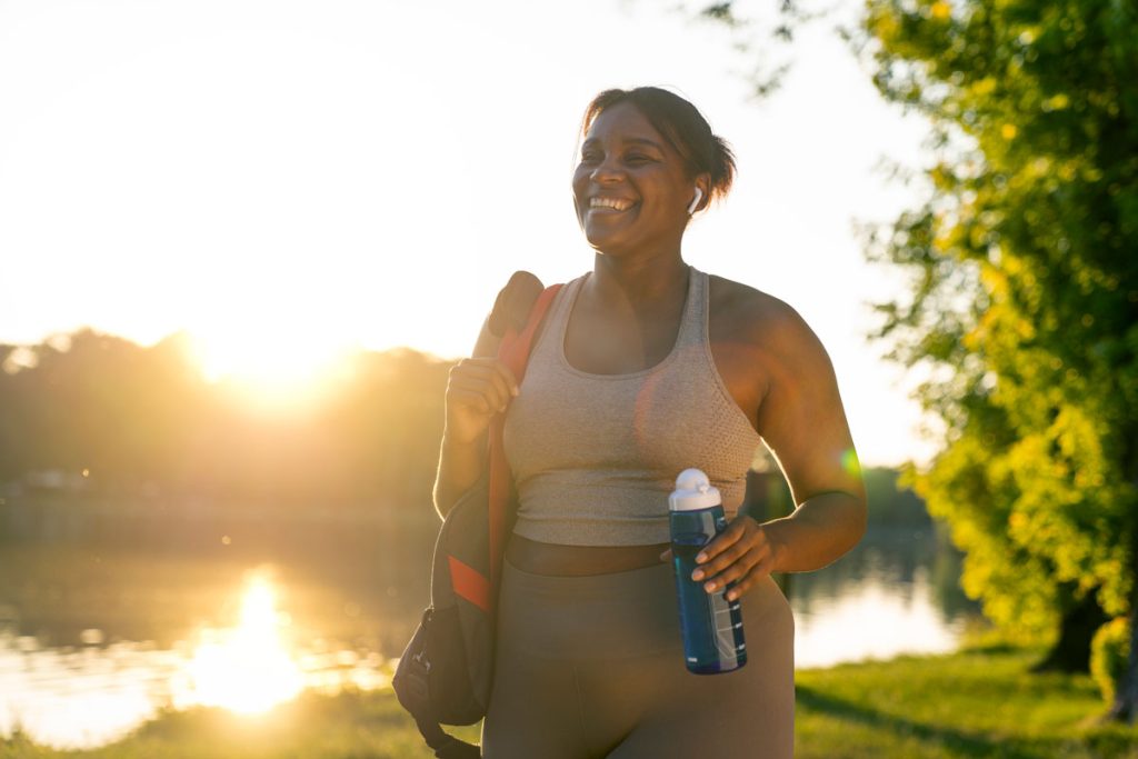 woman letting go of negative energy with walk through park