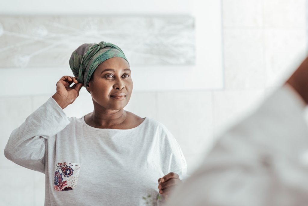 woman with self love looking at self in mirror