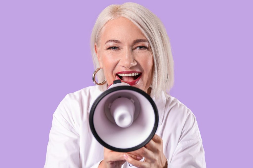 older woman speaking out on megaphone letting the world know about menopause