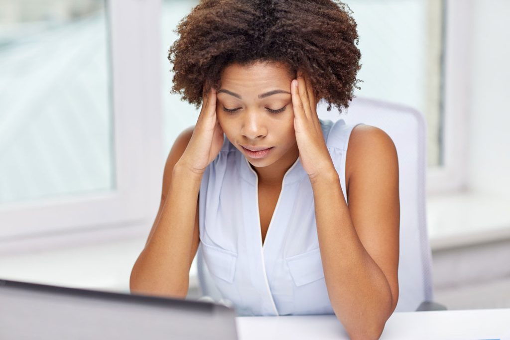 stressed woman with hands on head