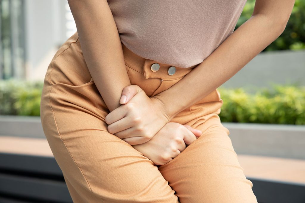 woman holding pee from overactive bladder and urinary concern