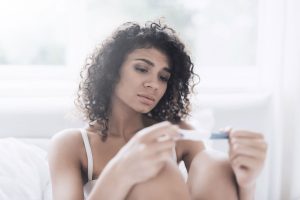 woman looking at pregnancy test