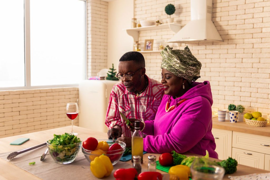 Woman making a healthy meal with husband