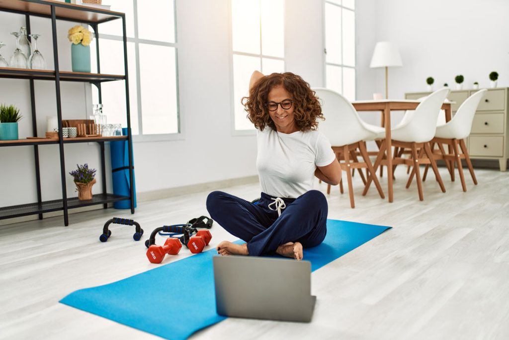 woman stretching at home with healthy lifestyle