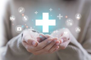 womans hands with healthcare options as icons representing healthcare benefits
