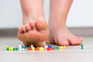 woman stepping on pins to symbolize menopause pins and needles sensation
