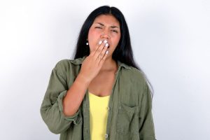 woman yawning from fatigue and exhaustion
