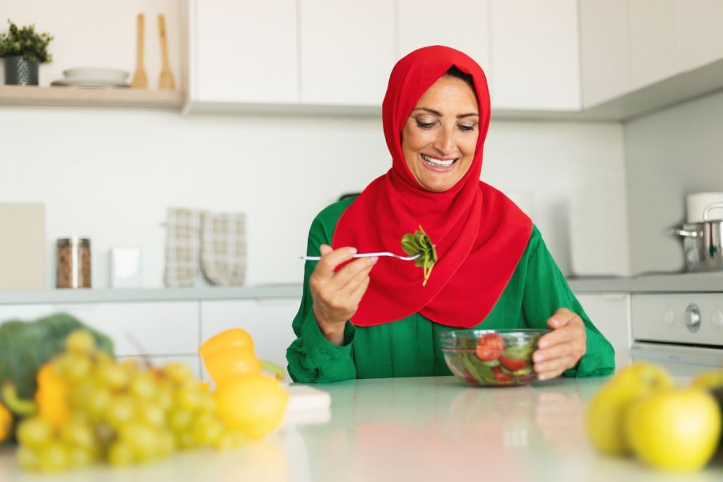 woman in hijab eating healthy foods