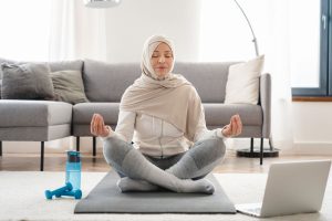 Muslim woman practicing mindfulness meditation after exercise