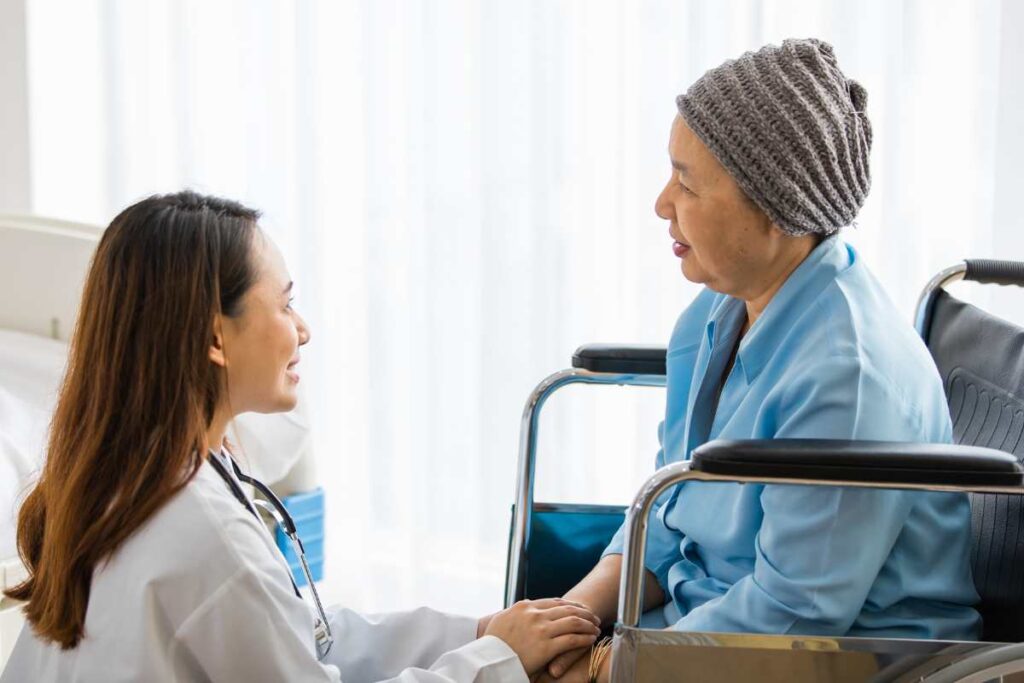 Asian cancer patient talking to doctor