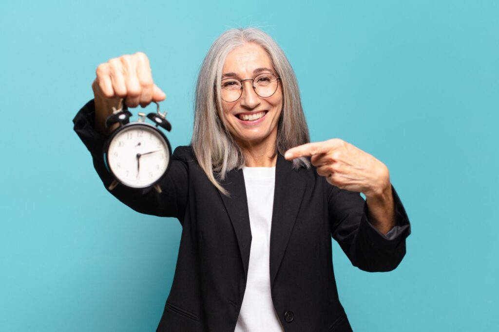 Employee holding a clock saying its time for a menopause friendly workplace