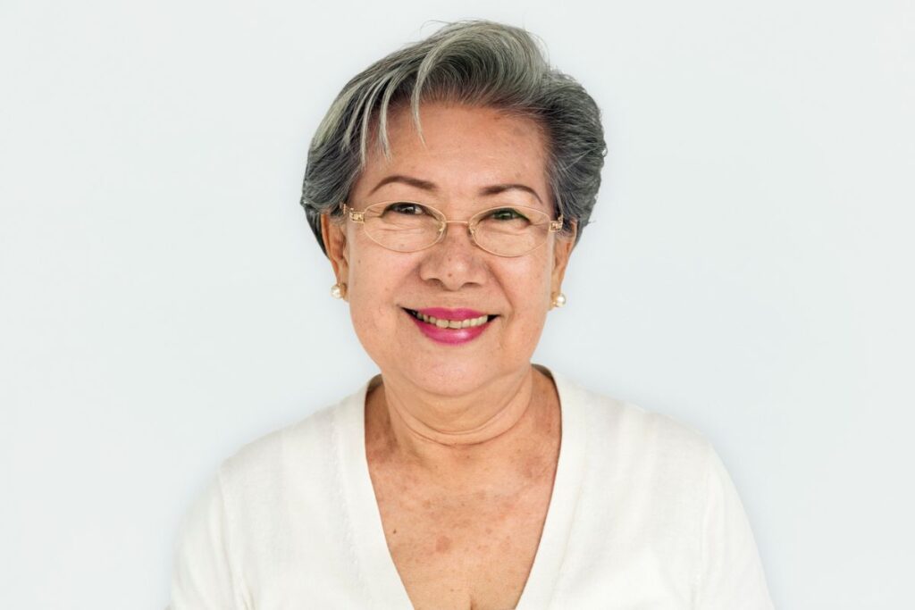 Gray haired Asian woman smiling