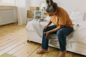 Woman holding leg from RLS pain