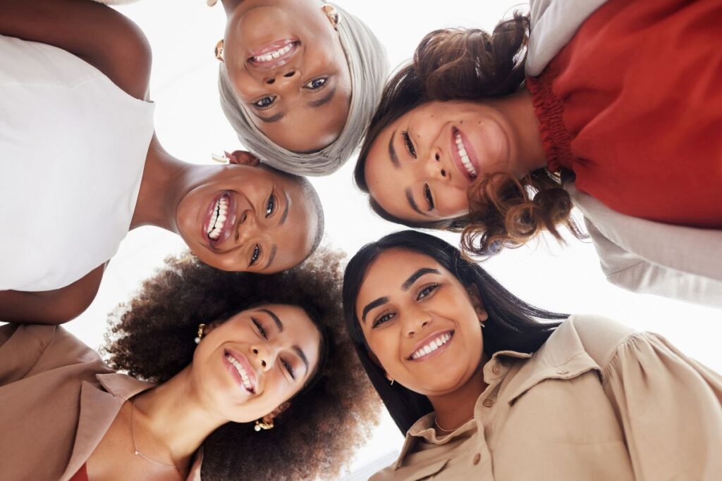 diverse women with their heads in a circle thinking about a positive mindset