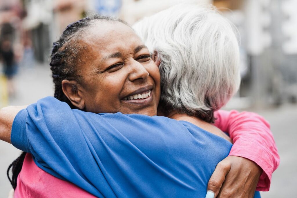 two women hugging socially