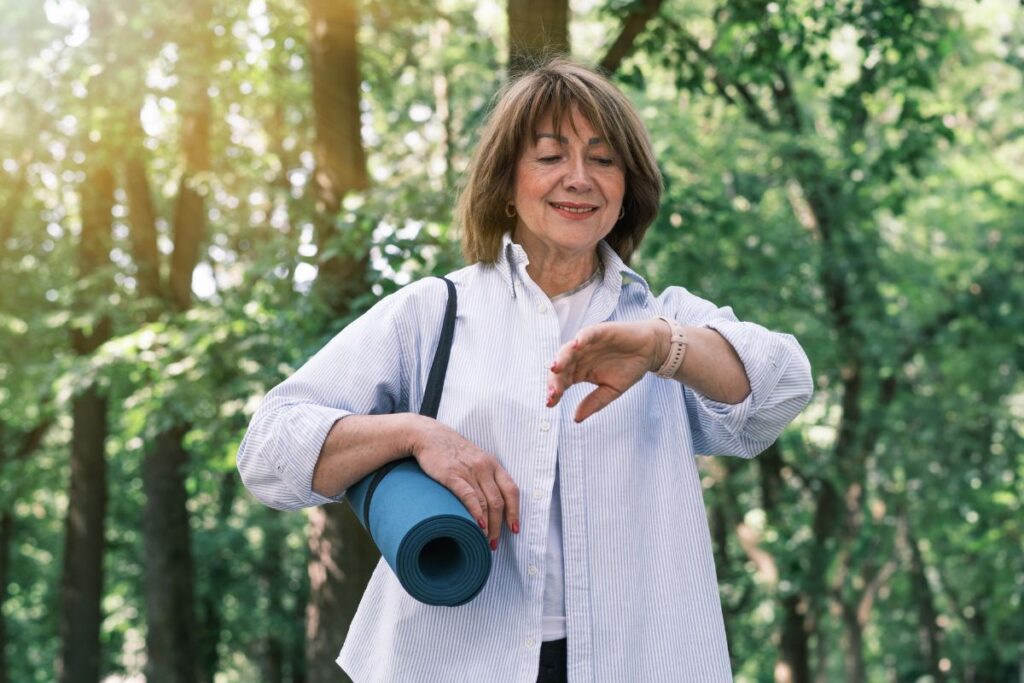 woman looking at wearable device for heart health