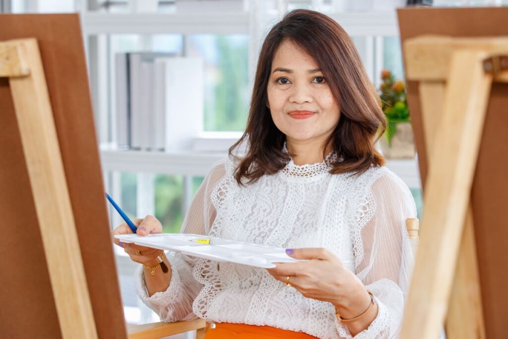 woman painting and using creativity