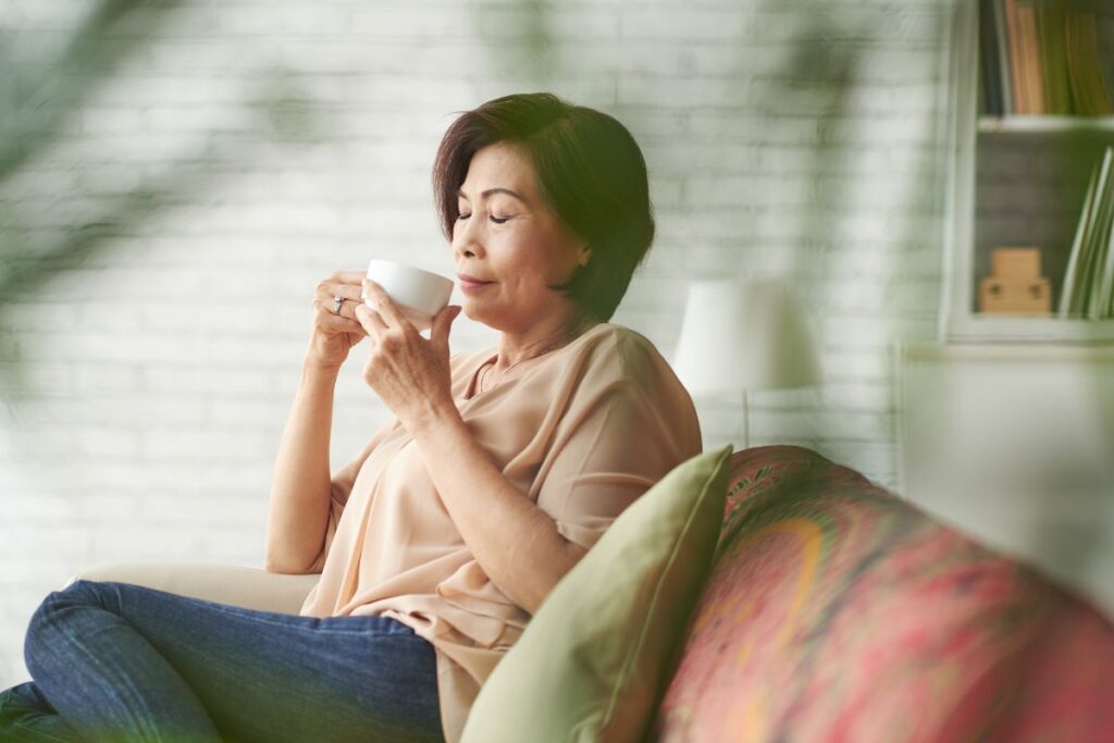 Woman practicing mindfulness as she drinks coffee