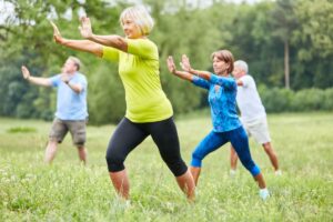 Women performing tai chi as a type of mindful movement