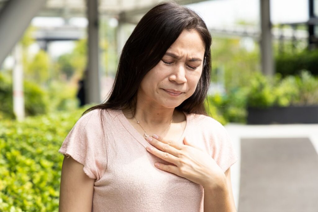 Woman suffering with acid reflux from osteoporosis medications