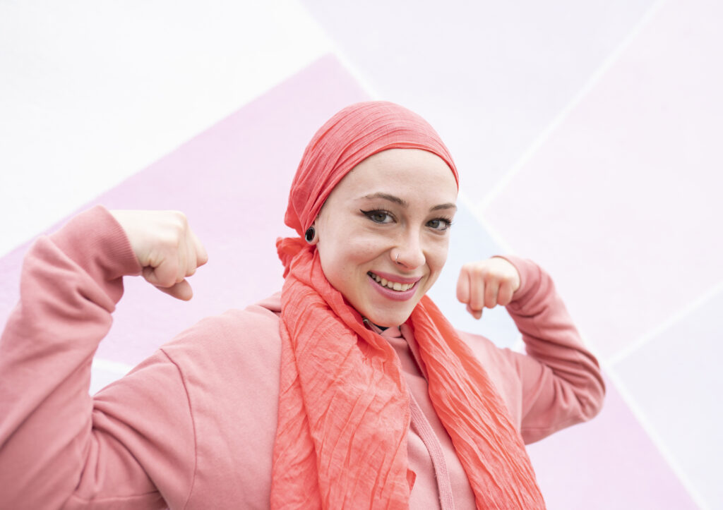 Cancer survivor flexing muscles