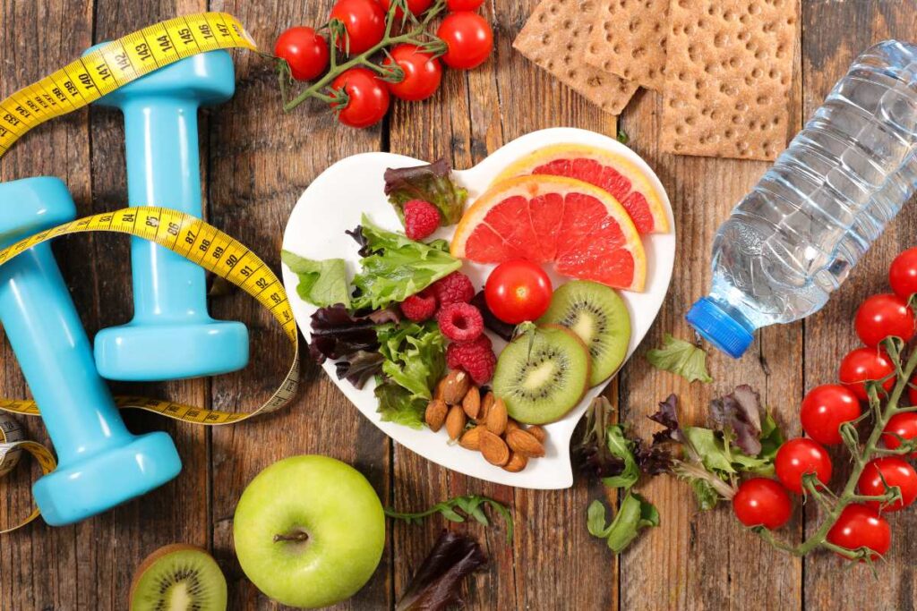 nutrition and healthy eating concept with food and weight