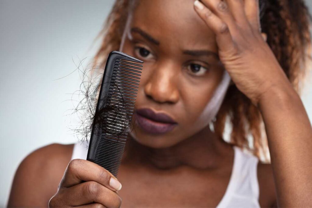 upset woman about hair loss in comb