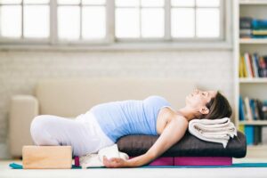 Supported reclining bound angle pose with blocks and blanket