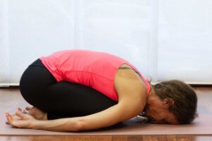 Woman practicing childs pose balasana