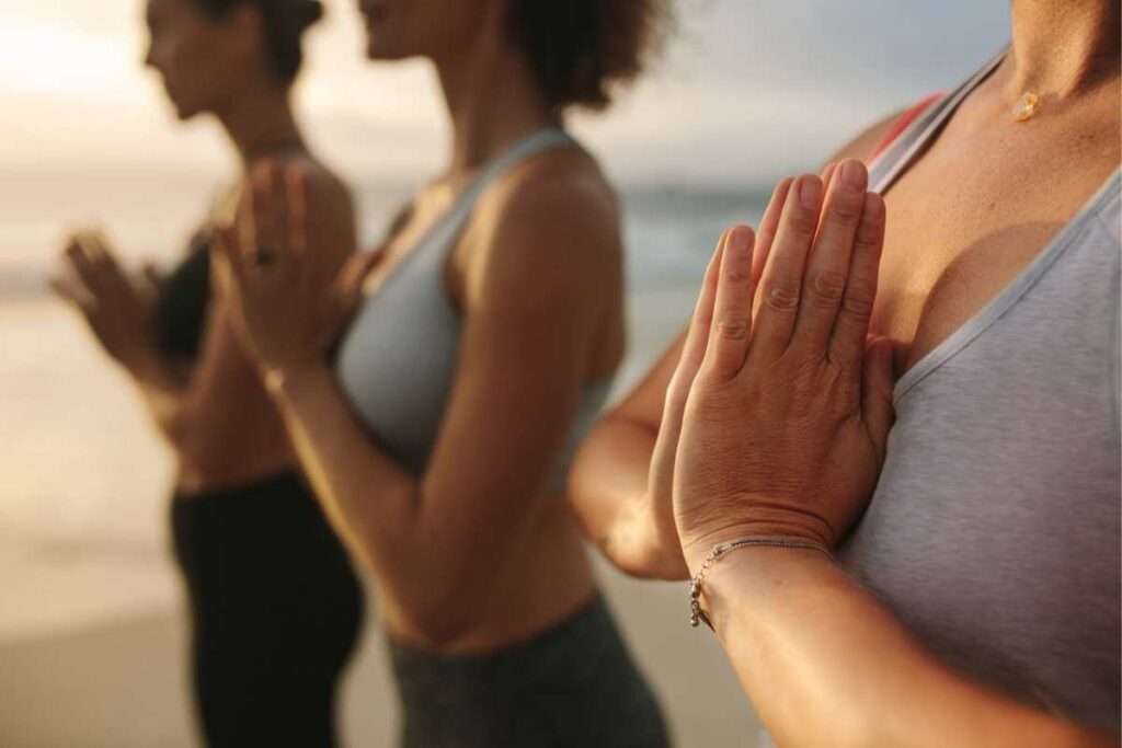 Women with hands to chest practicing mindfulness