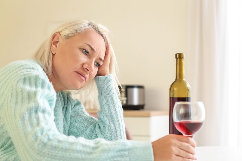 stressed woman drinking wine