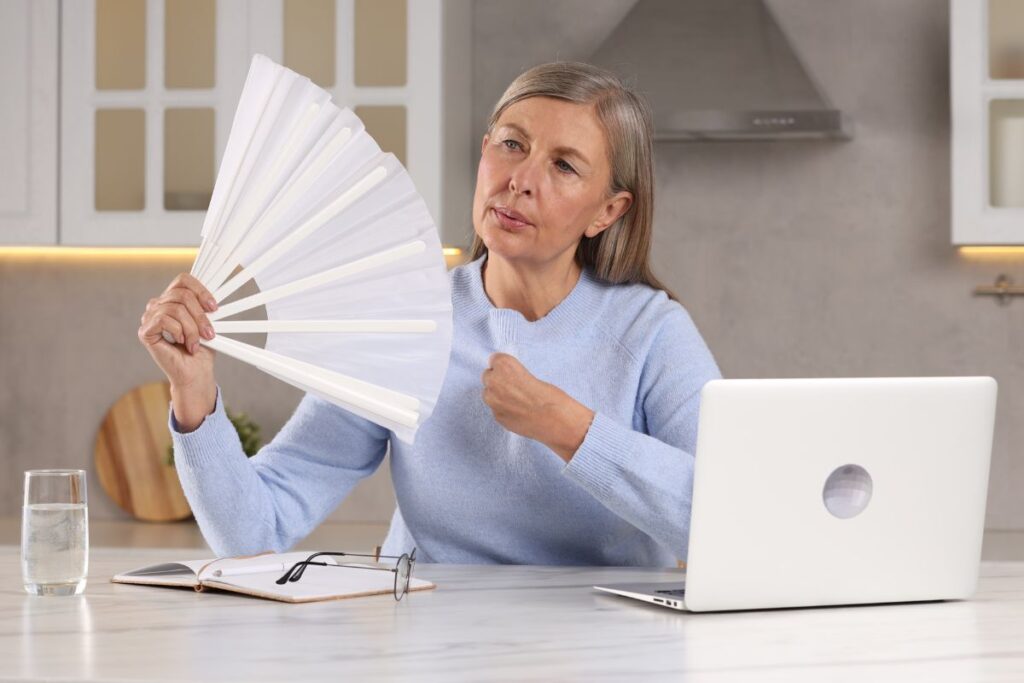 woman using fan during hot flash