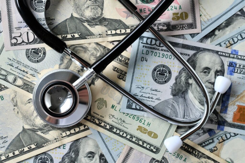 dollar bills and health care stethescope