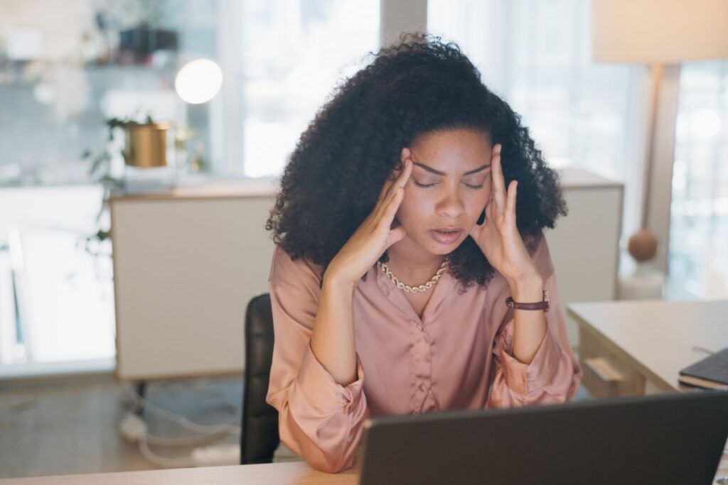 Stressed and overwhelmed woman at work