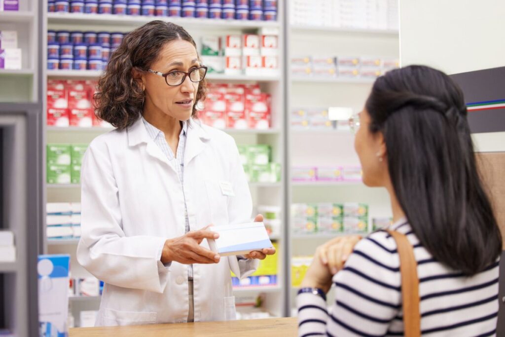 pharmacist talking to woman about hormones
